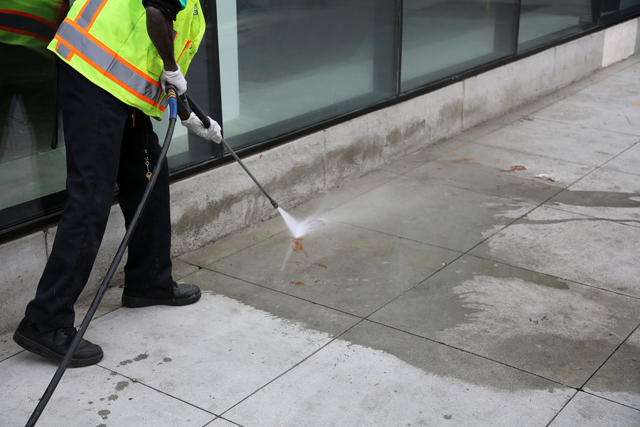 worker cleaning the concrete floor